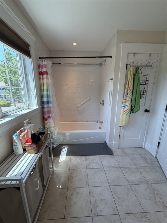 17 Cardinal Street, Unit 17 Winchester, MA 01890 - Photo 26 of 42 a bathroom with a tub shower and vanity