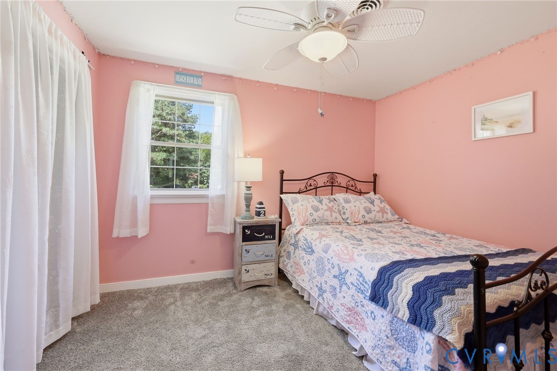 11200 Surry Road Chester, VA 23831 - Photo 27 of 48 a bedroom with a bed and a chandelier