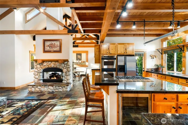 a kitchen view with a table and chairs