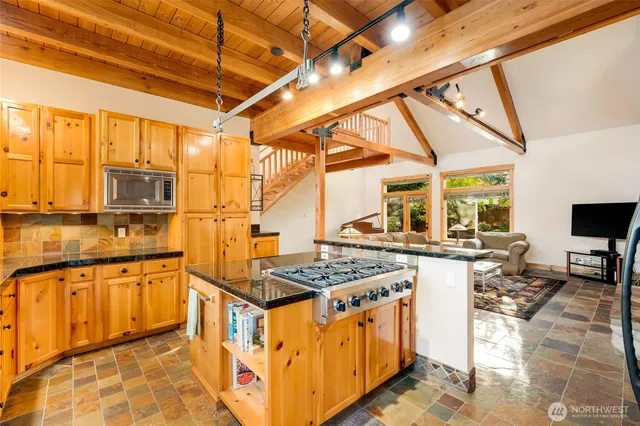 a kitchen with stainless steel appliances granite countertop a stove and a sink