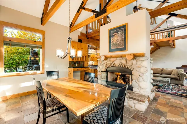a dining room with furniture and a floor to ceiling window