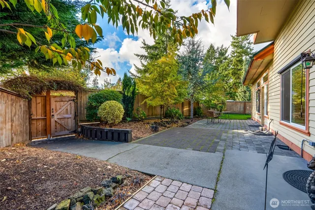 a backyard of a house with barbeque oven table and chairs