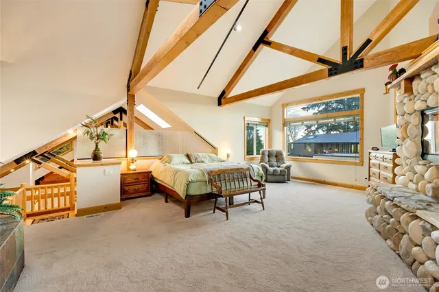 a bedroom with a bed a table and painting on the wall