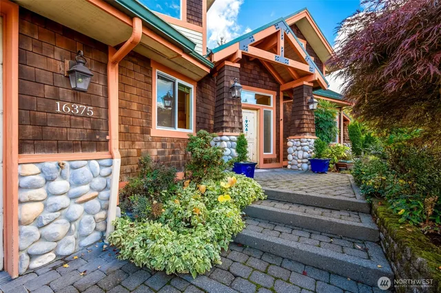a front view of a house with plants