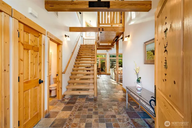a view of a hallway with wooden floor and staircase