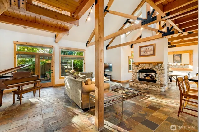 a living room with furniture a fireplace and a table