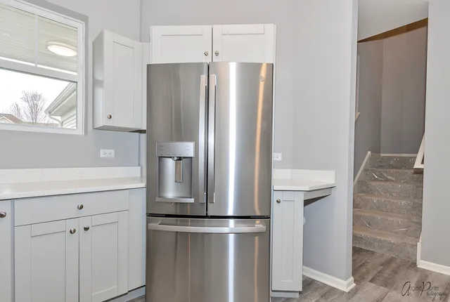 a kitchen with stainless steel appliances a refrigerator and cabinets