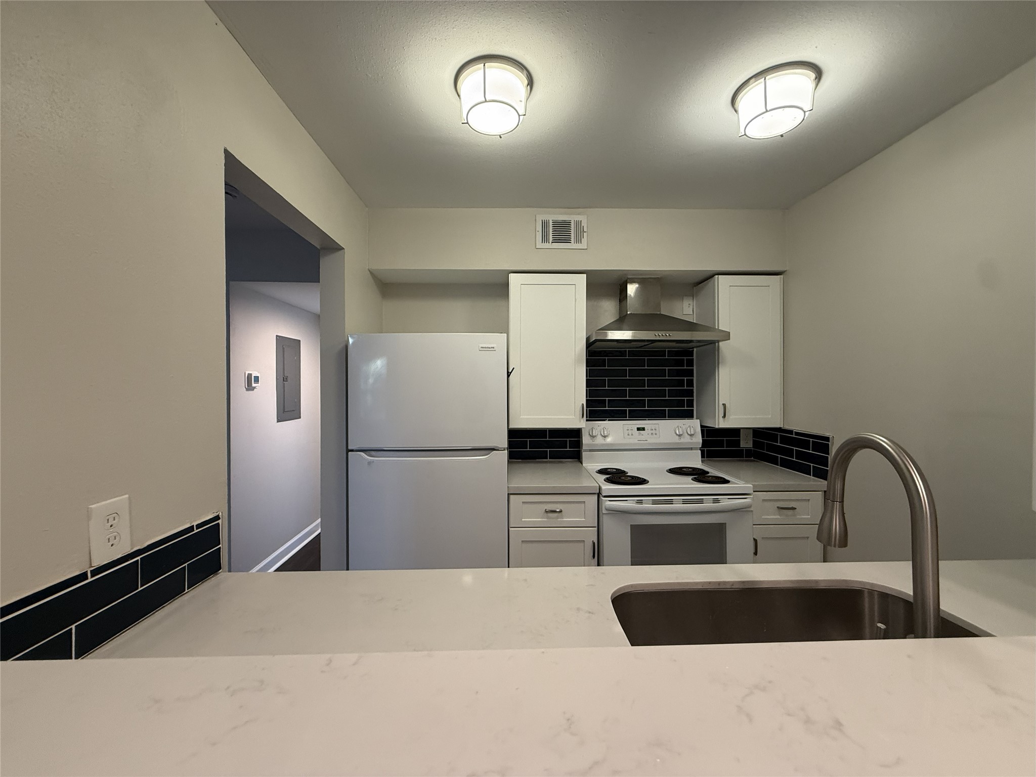 1824 Thonig Road, Unit 10 Houston, TX 77055 - Photo 5 of 17 a kitchen with kitchen island a sink stainless steel appliances and cabinets
