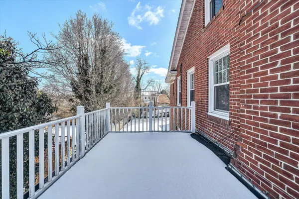 a view of a brick house with a small yard