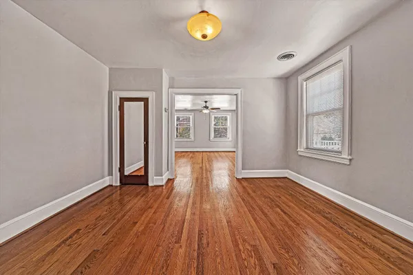 wooden floor in an empty room with a window