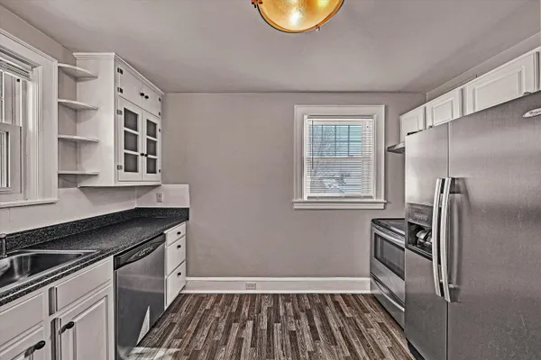 a kitchen with stainless steel appliances a refrigerator and a stove top oven