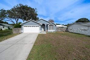 6727 Main Street New Port Richey, FL 34653 - Photo 1 of 1 a front view of a house with a garden