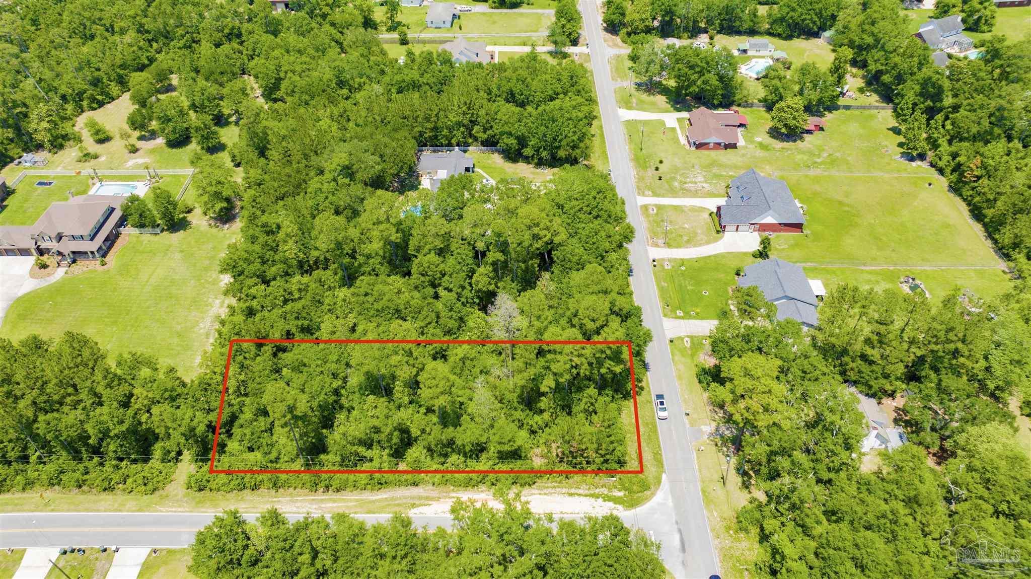 3195 Stefani Road Cantonment, FL 32533 - Photo 3 of 10 an aerial view of residential house with outdoor space and trees all around