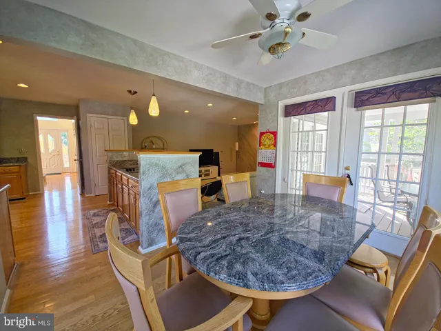 a view of a dining room with furniture a chandelier and wooden floor