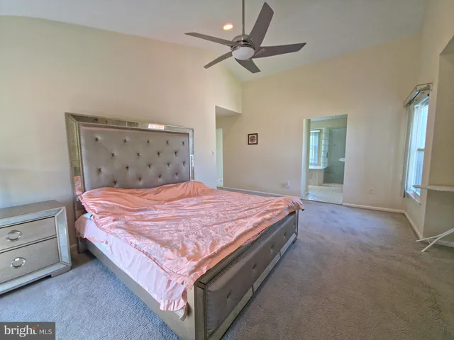 a bedroom with a bed and a television