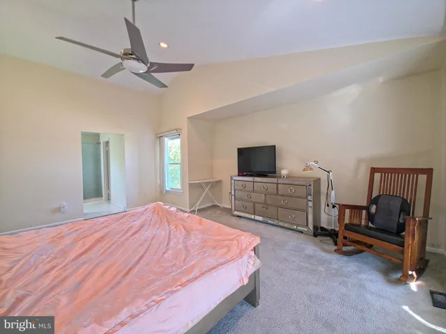 a bed room with a bed and a tv