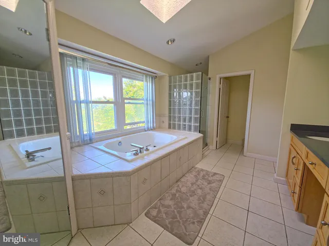 a spacious bathroom with a bathtub and a sink