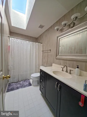 a bedroom with a bed and ceiling fan