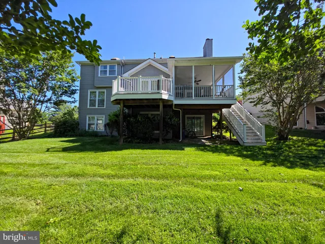 a view of house with garden and tall trees