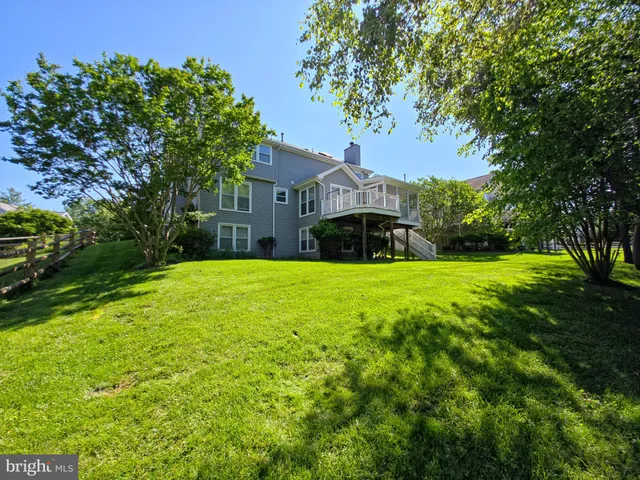 a front view of a house with yard and green space