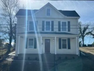 a large brick building next to a yard