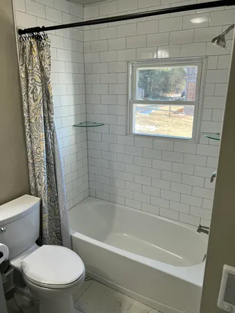 a bathroom with a toilet and a bathtub
