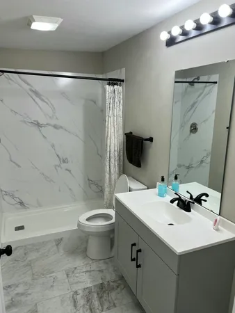 a bathroom with a sink toilet and shower