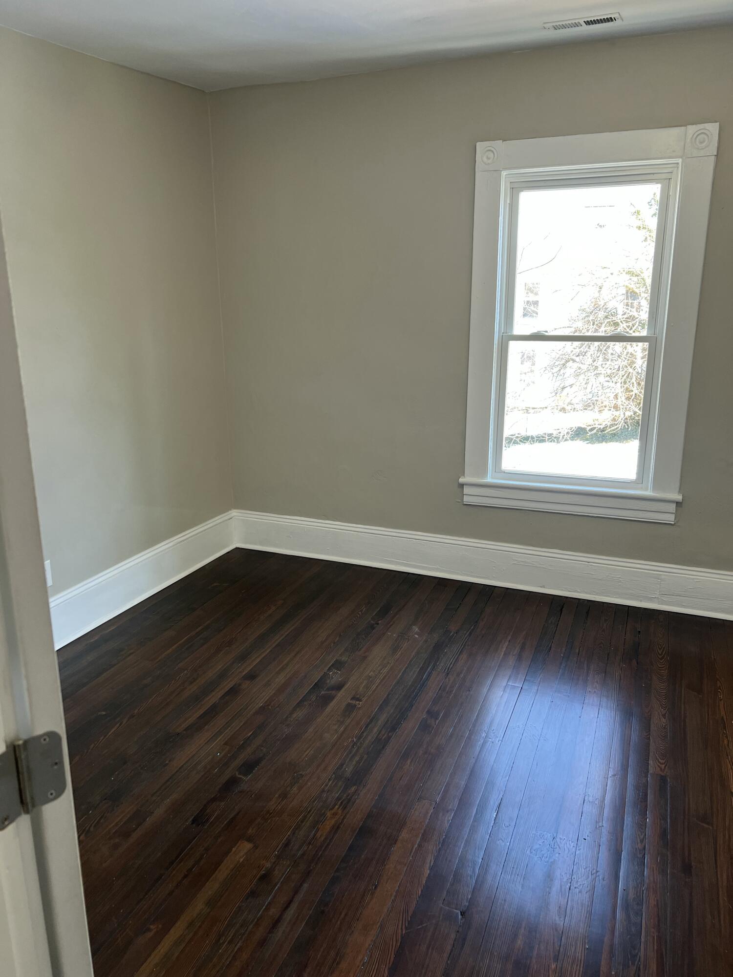 602 Rutherford Avenue Northwest Roanoke, VA 24016 - Photo 13 of 15 an empty room with wooden floor and windows