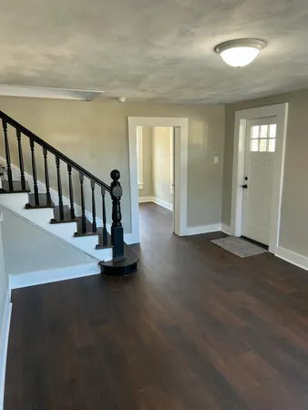 a view of an entryway with wooden floor