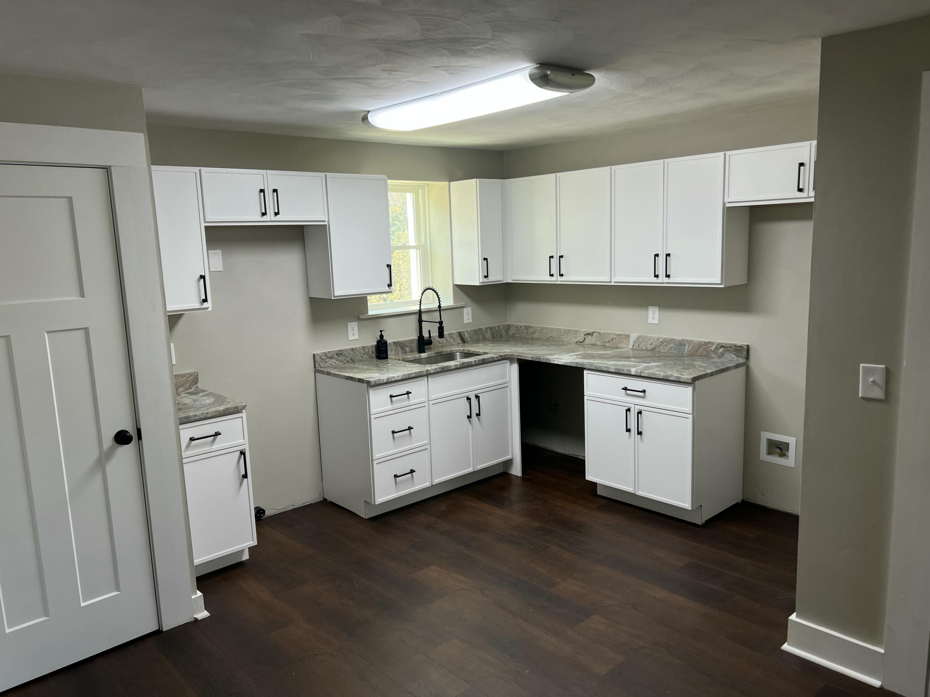 602 Rutherford Avenue Northwest Roanoke, VA 24016 - Photo 5 of 15 a kitchen with white cabinets and white appliances