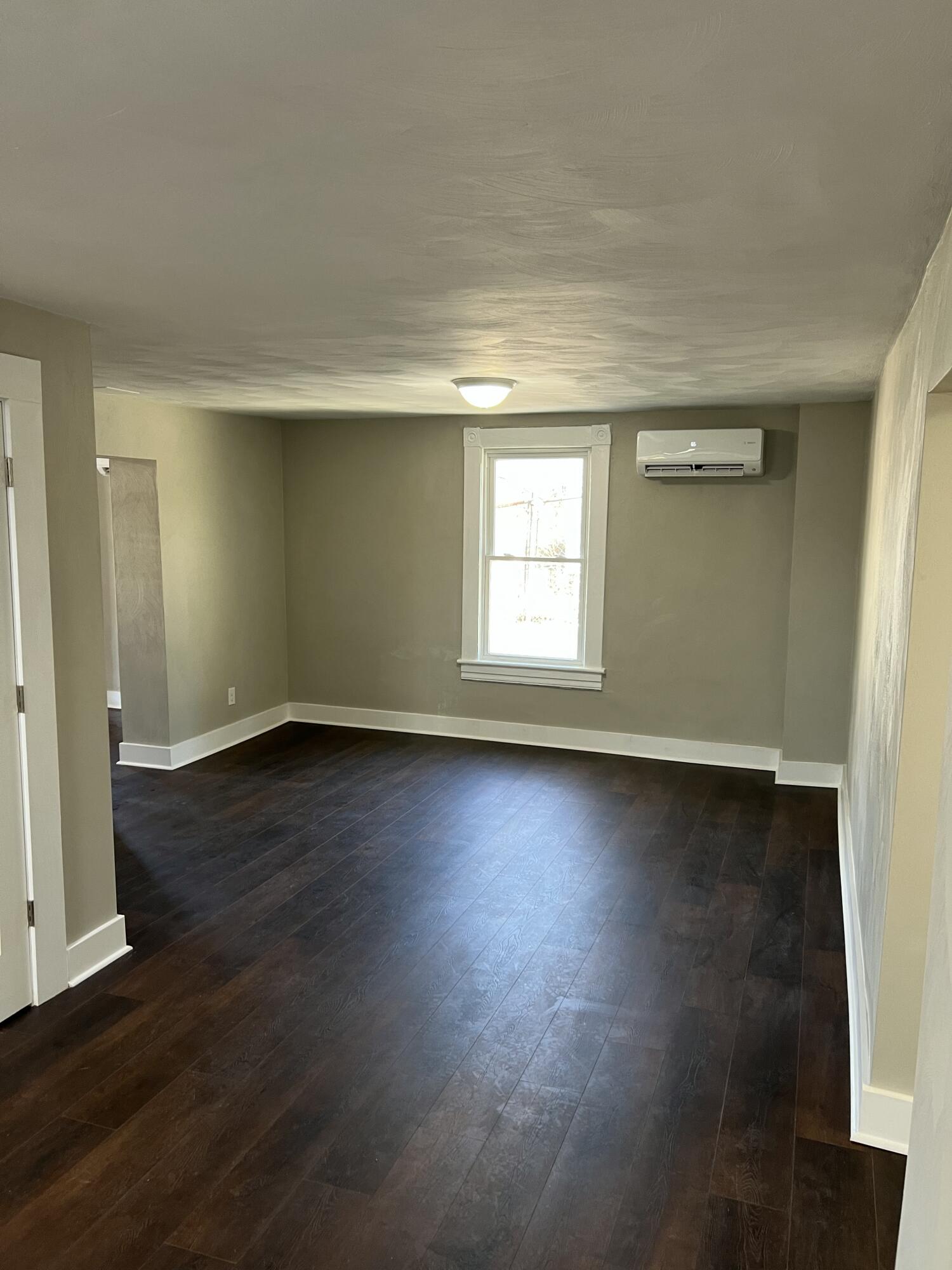 602 Rutherford Avenue Northwest Roanoke, VA 24016 - Photo 9 of 15 an empty room with wooden floor and windows