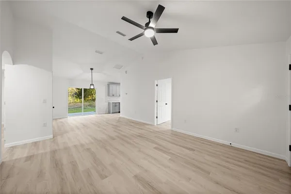 a view of a livingroom with a ceiling fan and window