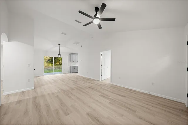 a view of a livingroom with a ceiling fan and window