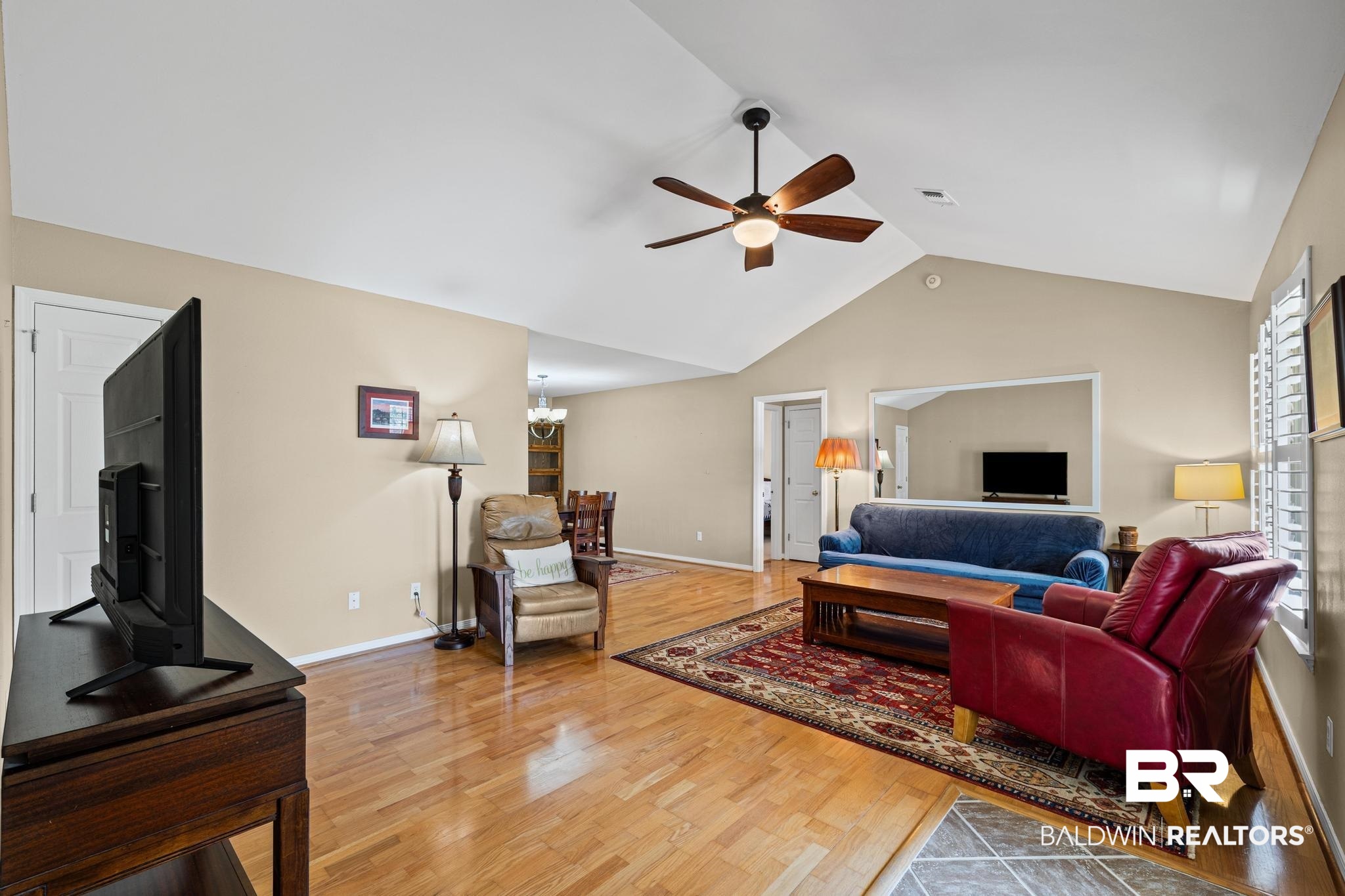 2881 Eslava Circle Lillian, AL 36549 - Photo 4 of 58 Living area featuring light wood finished floors, a ceiling fan, and a high ceiling