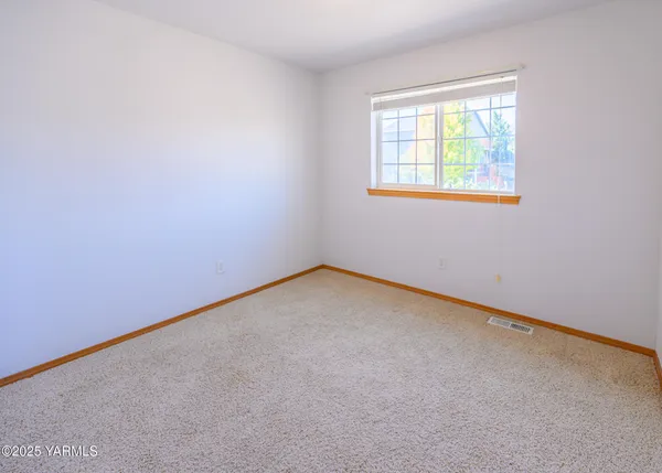 an empty room with windows and stairs