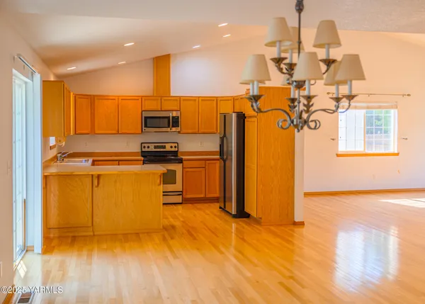a kitchen with stainless steel appliances a stove a refrigerator and a microwave