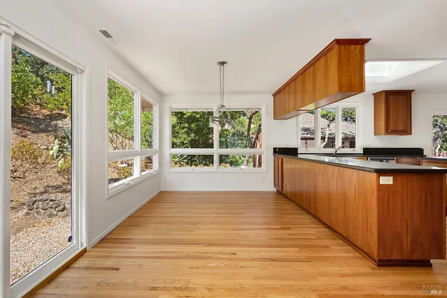 a kitchen with stainless steel appliances granite countertop a stove a sink and a large cabinets
