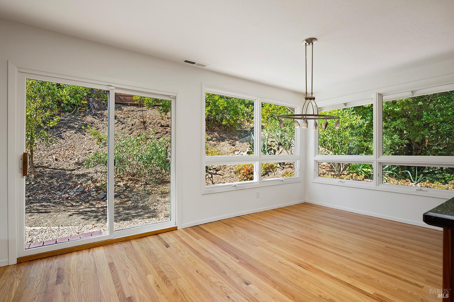 35 Salvador Way San Rafael, CA 94903 - Photo 12 of 46 a view of an empty room with wooden floor and a window