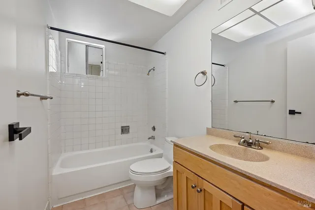 a bathroom with a sink toilet vanity and shower