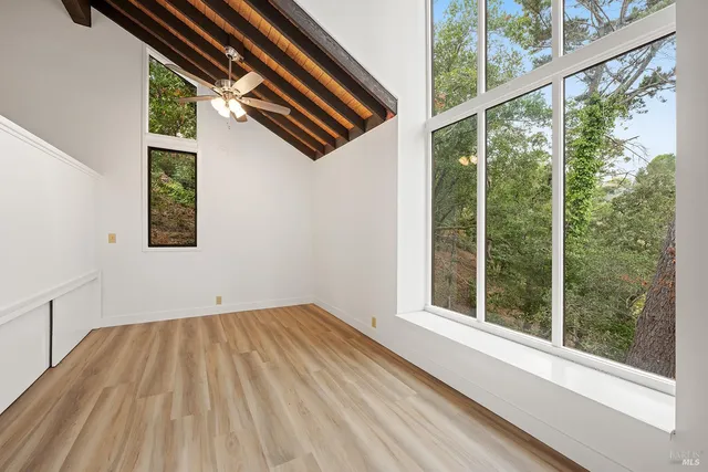 a view of balcony with wooden floor and outdoor seating