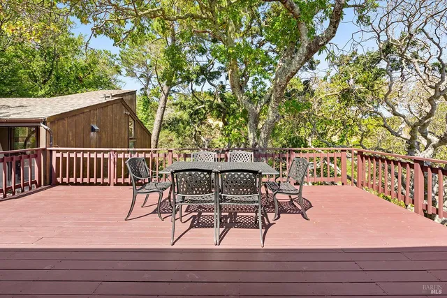a view of a roof deck with wooden floor and fence
