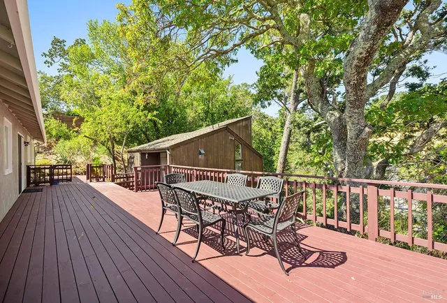 a view of a wooden deck and a yard