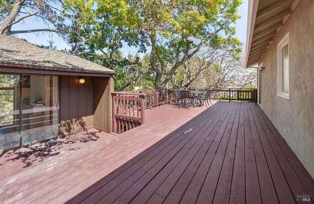 a outdoor view with a sitting space and large trees