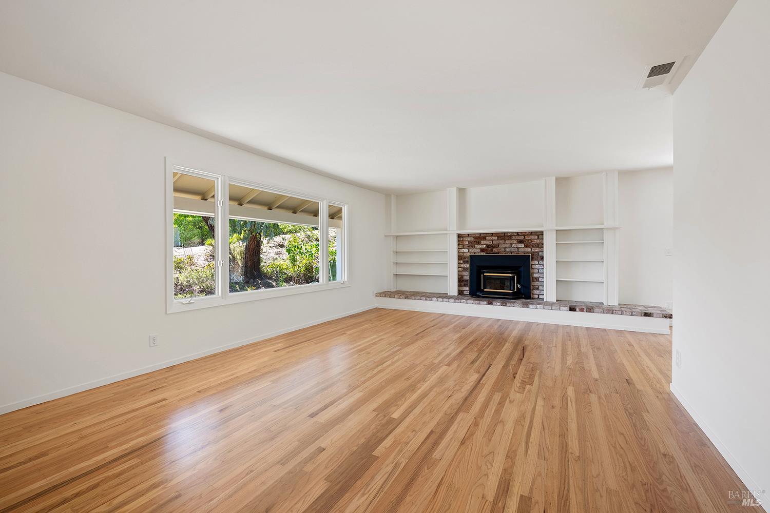 35 Salvador Way San Rafael, CA 94903 - Photo 7 of 46 a view of empty room with wooden floor and window