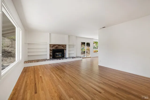 wooden floor in an empty room with a window