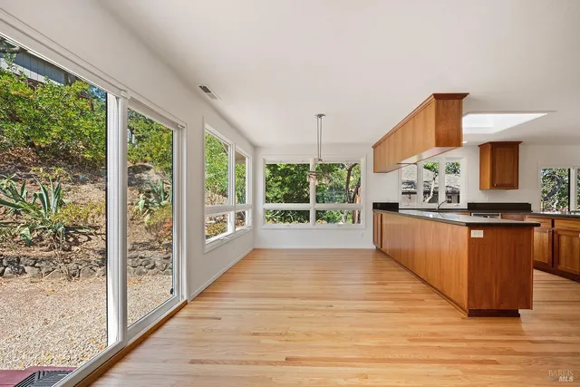 a large kitchen with kitchen island a large counter space and a wooden floor