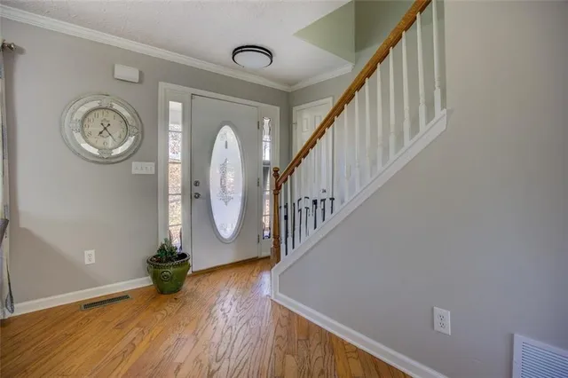 a view of a hallway with wooden floor