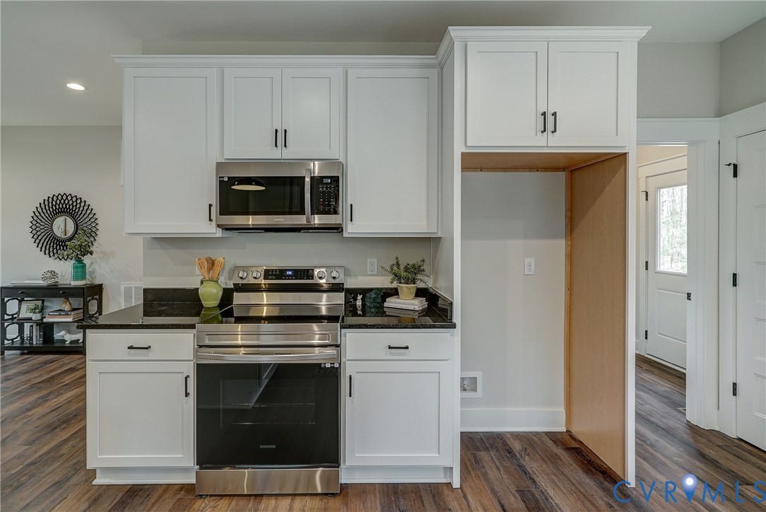 1343 Stokes Station Road Goochland, VA 23063 - Photo 17 of 35 a kitchen with stainless steel appliances granite countertop a stove a microwave and a refrigerator