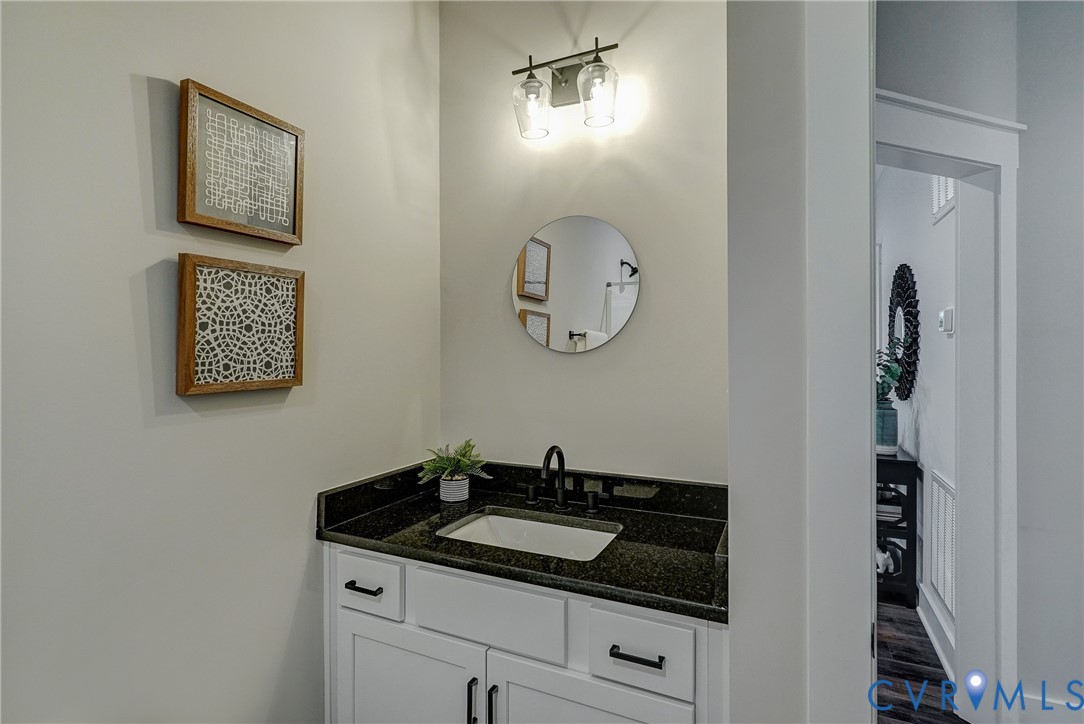 1343 Stokes Station Road Goochland, VA 23063 - Photo 22 of 35 a bathroom with a granite countertop sink and a mirror