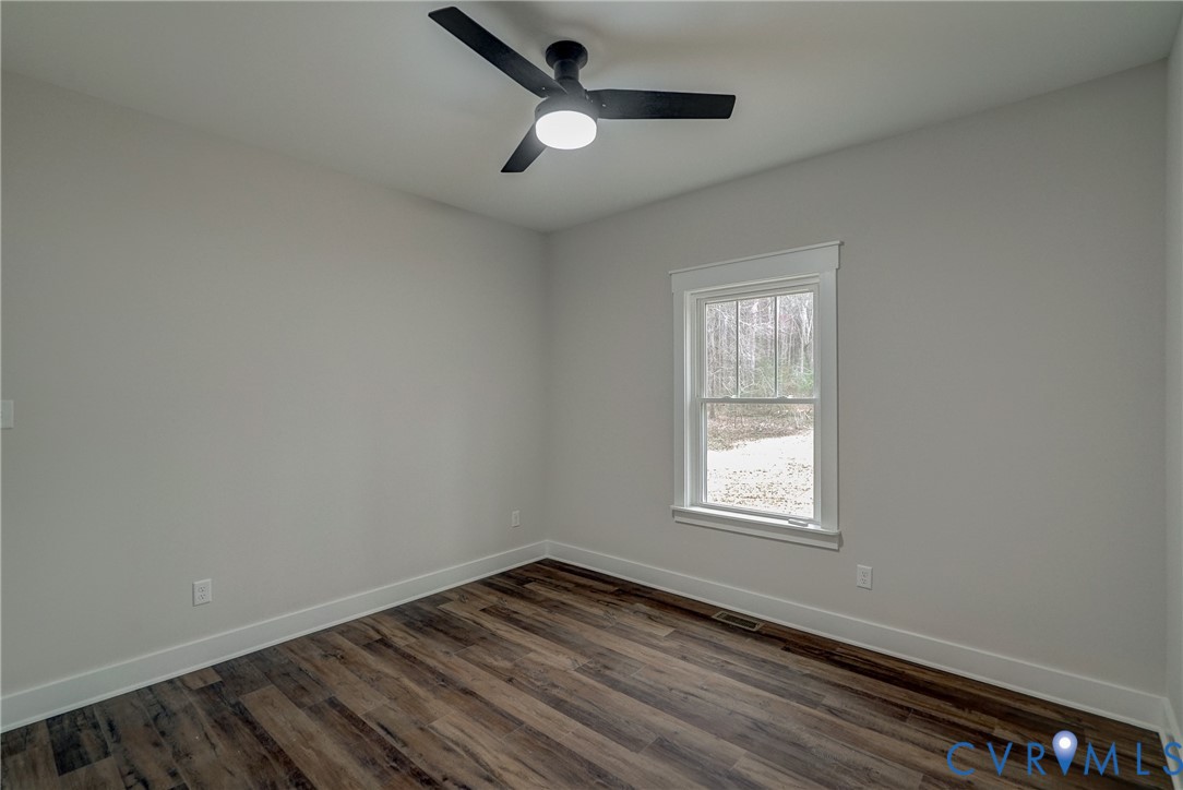 1343 Stokes Station Road Goochland, VA 23063 - Photo 24 of 35 wooden floor in an empty room with a window